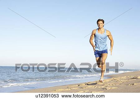 Young Man In Fitness Clothing Running Along Beach View Large Photo Image Stock Image - Young Man In Fitness Clothing Running Along Beach. Fotosearch