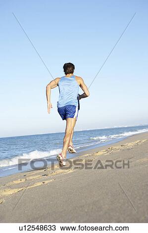 Young Man In Fitness Clothing Running Along Beach View Large Photo Image Stock Image - Young Man In Fitness Clothing Running Along Beach. Fotosearch