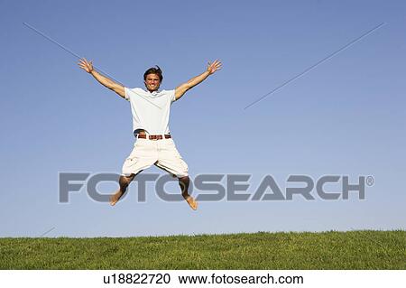 Young man jumping in air View Large Photo Image Stock Image - Young man jumping in air. Fotosearch