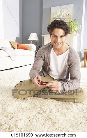 Young Man Looking At Photograph On Digital Camera At Home View Large Photo Image Stock Image - Young Man Looking At Photograph On Digital Camera At Home . Fotosearch