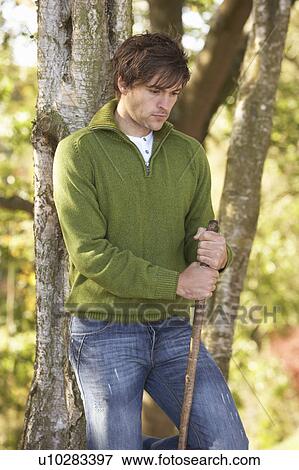 Young Man Outdoors Walking In Autumn Woodland Holding Walking Stick View Large Photo Image Stock Photo - Young Man Outdoors Walking In Autumn Woodland Holding Walking Stick. Fotosearch