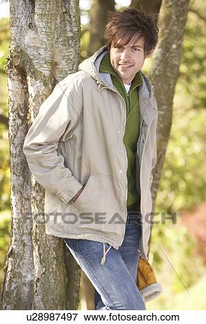 Young Man Outdoors Walking In Autumn Woodland View Large Photo Image Stock Photo - Young Man Outdoors Walking In Autumn Woodland. Fotosearch