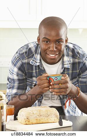Young Man Preparing Breakfast In Modern Kitchen View Large Photo Image Picture - Young Man Preparing Breakfast In Modern Kitchen . Fotosearch