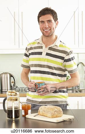 Young Man Preparing Breakfast In Modern Kitchen View Large Photo Image Stock Photograph - Young Man Preparing Breakfast In Modern Kitchen . Fotosearch