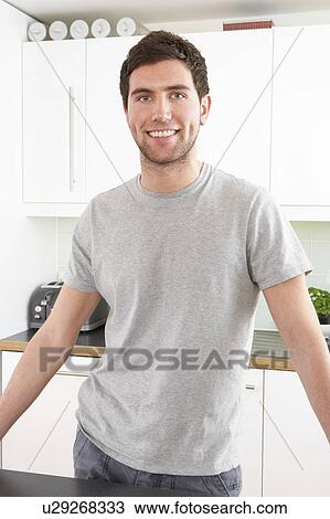 Young Man Relaxing In Modern Kitchen View Large Photo Image Stock Image - Young Man Relaxing In Modern Kitchen . Fotosearch