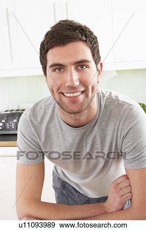 Young Man Relaxing In Modern Kitchen View Large Photo Image Stock Photo - Young Man Relaxing In Modern Kitchen . Fotosearch