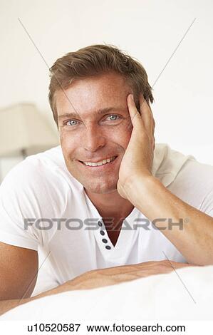 Young Man Relaxing On Bed View Large Photo Image Stock Photo - Young Man Relaxing On Bed. Fotosearch