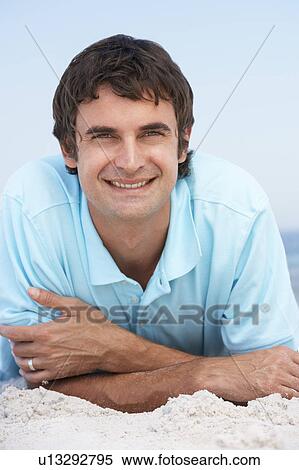 Young Man Relaxing On Sandy Beach View Large Photo Image Stock Photography - Young Man Relaxing On Sandy Beach. Fotosearch
