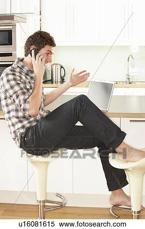 Young Man Relaxing Sitting In Kitchen Talking On Phone View Large Photo Image Stock Photography - Young Man Relaxing Sitting In Kitchen Talking On Phone. Fotosearch