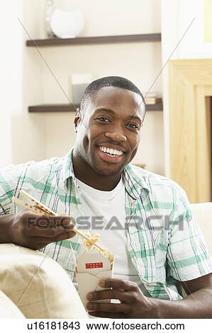 Young Man Relaxing Sitting On Sofa At Eating Chinese Meal At Home View Large Photo Image Stock Image - Young Man Relaxing Sitting On Sofa At Eating Chinese Meal At Home . Fotosearch