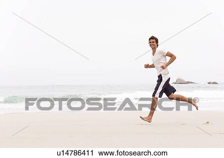 Young Man Running Along Winter Beach View Large Photo Image Stock Image - Young Man Running Along Winter Beach. Fotosearch
