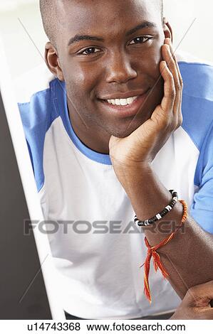 Young Man Using Computer In Modern Kitchen View Large Photo Image Stock Photo - Young Man Using Computer In Modern Kitchen . Fotosearch