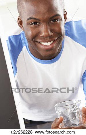 Young Man Using Computer In Modern Kitchen View Large Photo Image Stock Photo - Young Man Using Computer In Modern Kitchen . Fotosearch