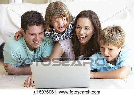 Young parents, with children, on laptop computer View Large Photo Image Stock Image - Young parents, with children, on laptop computer. Fotosearch