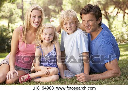 Young parents with children posing in a park View Large Photo Image Stock Image - Young parents with children posing in a park. Fotosearch