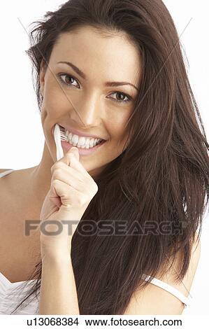 Young Woman Brushing Teeth In Studio View Large Photo Image Picture - Young Woman Brushing Teeth In Studio. Fotosearch