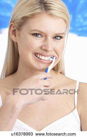 Young Woman Brushing Teeth In Studio View Large Photo Image Stock Image - Young Woman Brushing Teeth In Studio. Fotosearch