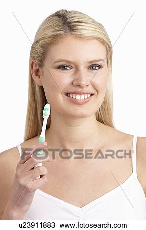 Young Woman Brushing Teeth In Studio View Large Photo Image Stock Image - Young Woman Brushing Teeth In Studio. Fotosearch