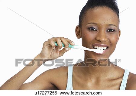 Young Woman Brushing Teeth In Studio View Large Photo Image Stock Photography - Young Woman Brushing Teeth In Studio. Fotosearch