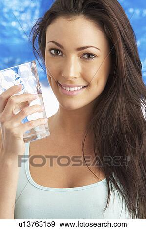 Young Woman Drinking Glass Of Water In Studio View Large Photo Image Stock Photo - Young Woman Drinking Glass Of Water In Studio. Fotosearch