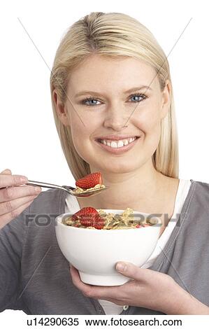 Young Woman Eating Bowl Of Healthy Breakfast Cereal In Studio View Large Photo Image Stock Photography - Young Woman Eating Bowl Of Healthy Breakfast Cereal In Studio. Fotosearch