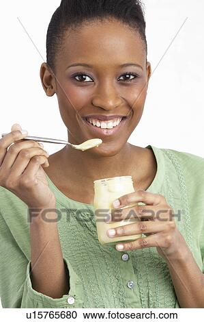 Young Woman Eating Yoghurt In Studio View Large Photo Image Stock Image - Young Woman Eating Yoghurt In Studio. Fotosearch