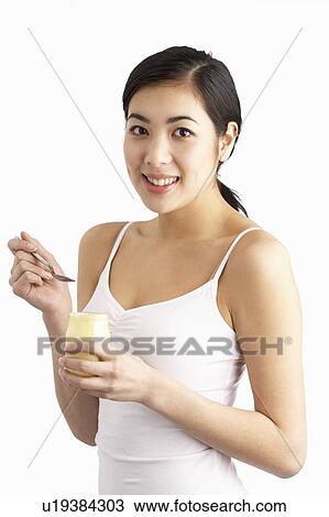 Young Woman Eating Yoghurt In Studio View Large Photo Image Stock Image - Young Woman Eating Yoghurt In Studio. Fotosearch