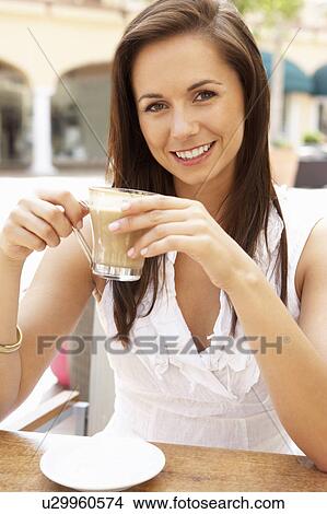 Young Woman Enjoying Cup Of Coffee In Café View Large Photo Image Picture - Young Woman Enjoying Cup Of Coffee In Café. Fotosearch