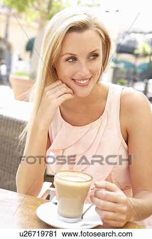 Stock Image - Young Woman Enjoying Cup Of Coffee In Café. Fotosearch