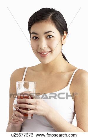 Young Woman Enjoying Healthy Drink In Studio View Large Photo Image Stock Image - Young Woman Enjoying Healthy Drink In Studio. Fotosearch
