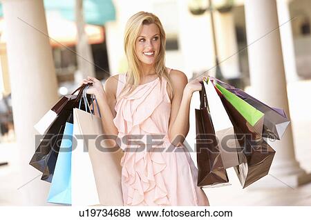Stock Photo - Young Woman Enjoying Shopping Trip . Fotosearch