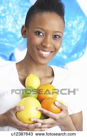 Young Woman Holding Citrus Fruit In Studio View Large Photo Image Stock Image - Young Woman Holding Citrus Fruit In Studio. Fotosearch