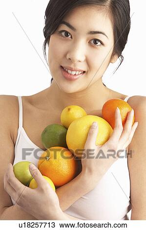 Young Woman Holding Citrus Fruit In Studio View Large Photo Image Stock Image - Young Woman Holding Citrus Fruit In Studio. Fotosearch