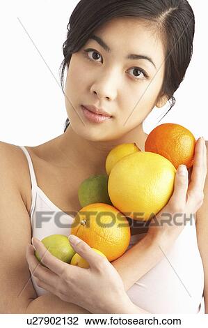 Young Woman Holding Citrus Fruit In Studio View Large Photo Image Stock Image - Young Woman Holding Citrus Fruit In Studio. Fotosearch