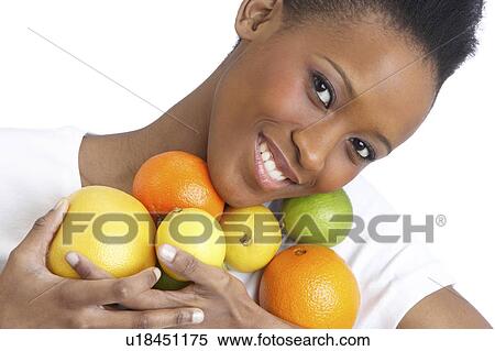 Young Woman Holding Citrus Fruit In Studio View Large Photo Image Stock Photography - Young Woman Holding Citrus Fruit In Studio. Fotosearch
