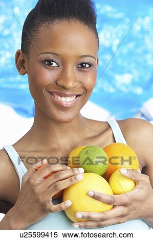 Young Woman Holding Citrus Fruit In Studio View Large Photo Image Stock Photography - Young Woman Holding Citrus Fruit In Studio. Fotosearch