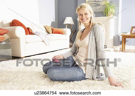 Young Woman Looking At Photograph On Digital Camera At Home View Large Photo Image Picture - Young Woman Looking At Photograph On Digital Camera At Home . Fotosearch
