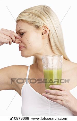 Young Woman Not Enjoying Healthy Drink In Studio View Large Photo Image Stock Photo - Young Woman Not Enjoying Healthy Drink In Studio. Fotosearch