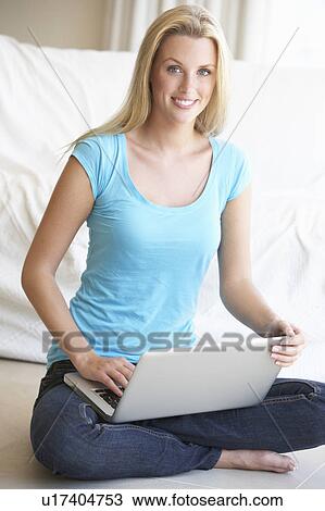 Stock Image - Young woman on her laptop computer. Fotosearch