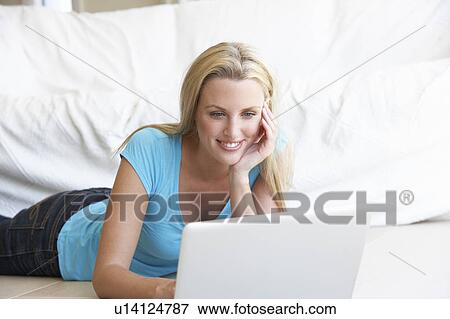 Young woman on her laptop computer View Large Photo Image Stock Photo - Young woman on her laptop computer. Fotosearch