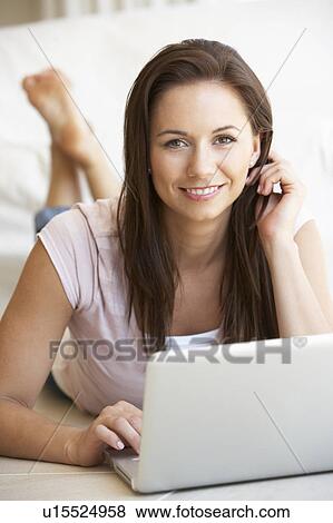 Young woman on her laptop computer View Large Photo Image Stock Photo - Young woman on her laptop computer. Fotosearch