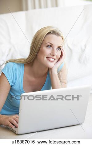 Stock Photograph - Young woman on her laptop computer. Fotosearch