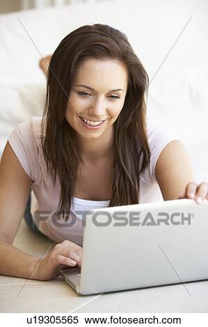 Young woman on her laptop computer View Large Photo Image Stock Photography - Young woman on her laptop computer. Fotosearch