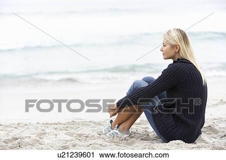 Young Woman On Holiday Sitting On Winter Beach View Large Photo Image Stock Image - Young Woman On Holiday Sitting On Winter Beach. Fotosearch