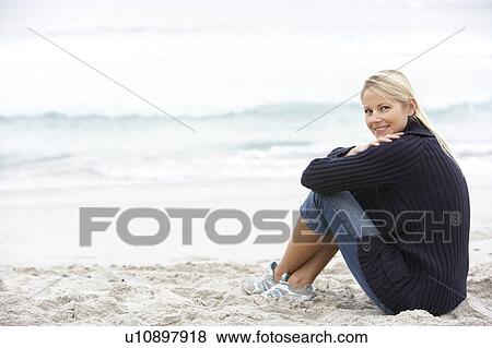 Young Woman On Holiday Sitting On Winter Beach View Large Photo Image Stock Photo - Young Woman On Holiday Sitting On Winter Beach. Fotosearch