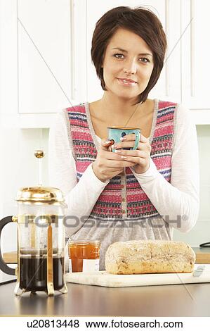 Young Woman Preparing Breakfast In Modern Kitchen View Large Photo Image Stock Photo - Young Woman Preparing Breakfast In Modern Kitchen . Fotosearch