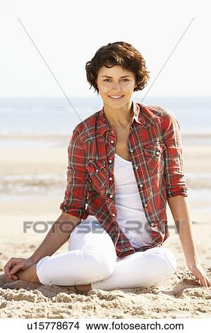 Picture - Young Woman Relaxing On Beach. Fotosearch