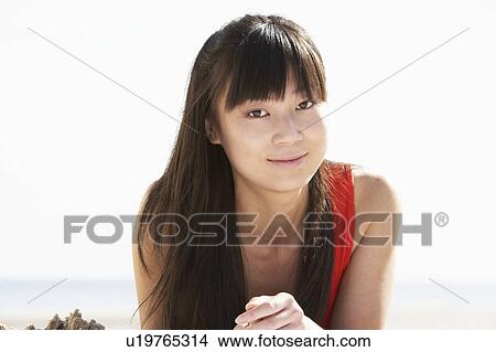 Picture - Young Woman Relaxing On Beach. Fotosearch