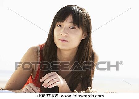 Young Woman Relaxing On Beach View Large Photo Image Stock Photo - Young Woman Relaxing On Beach. Fotosearch