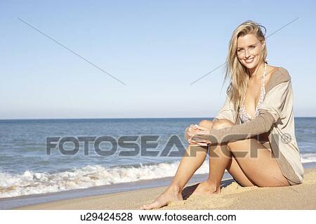 Stock Photo - Young Woman Relaxing On Beach. Fotosearch